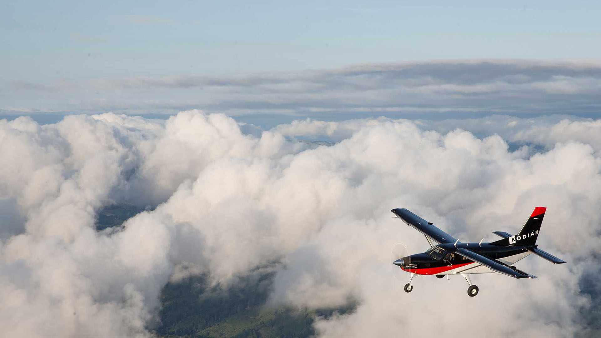Kodiak 1 kodiak plane in flight among the clouds