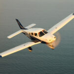 Thumbnail of piper archer lx flying over the water