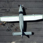 Thumbnail of several kids' bikes on the ground around an airplane